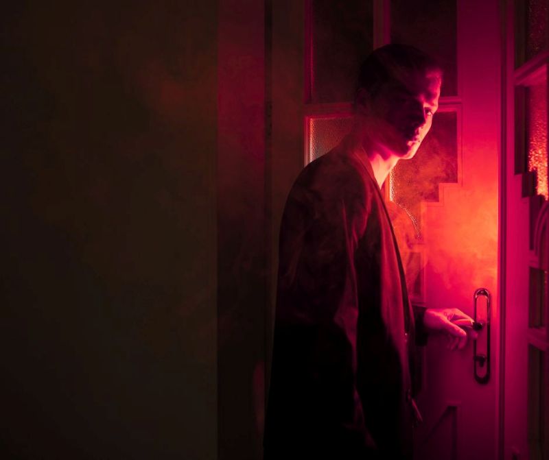 Man solving clues to beat escape room faster.